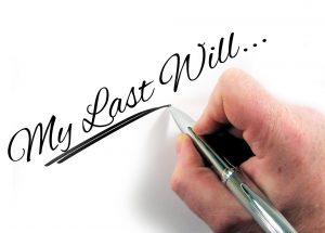 Someone writing 'My Last Will...'